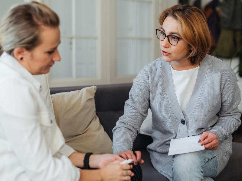 A carer having a one-to-one conversation about support.